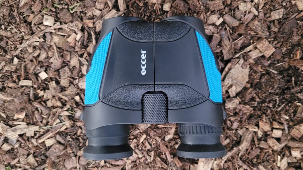 Occur 12x25 Compact Binoculars, fitting comfortably in the palm of a hand.
