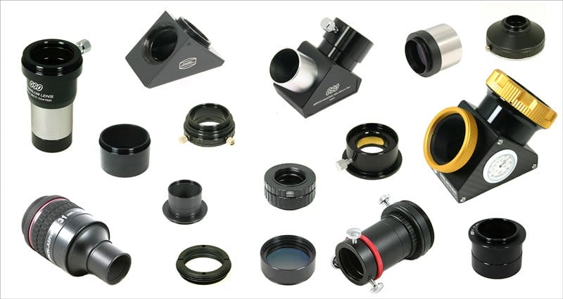 A collection of various circular telescope lenses laid out on a white background. The lenses come in different sizes and have a slight curve to their surface.