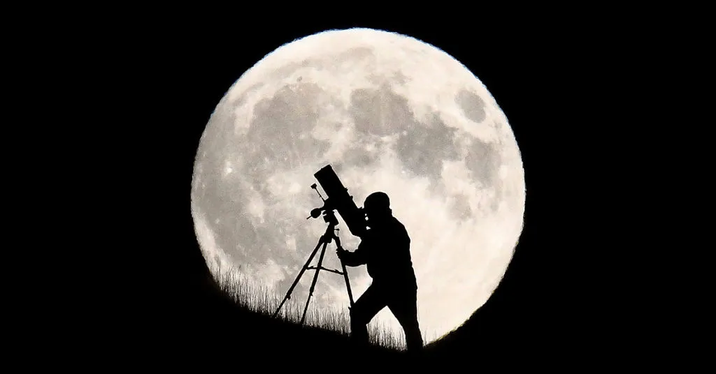 A man using a telescope to observe moon