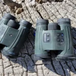 A black Vortex Fury HD 5000 Rangefinding Binocular mounted on a tripod.