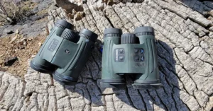 A black Vortex Fury HD 5000 Rangefinding Binocular mounted on a tripod.