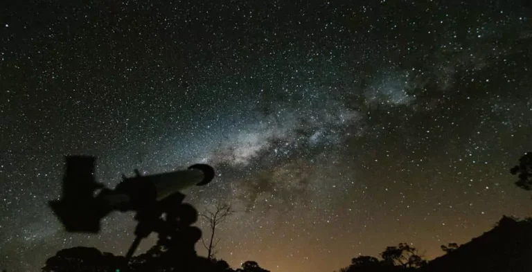 A telescope under the dark night sky