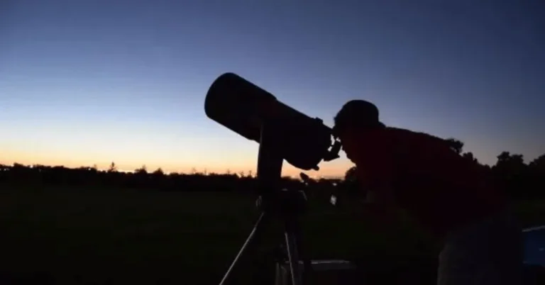 A Man using a telescope during the day Day Time astronomy